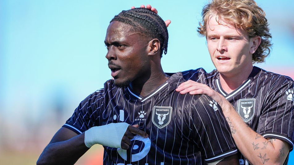 Musa Touré of Macarthur FC celebrates with Ben Gibson of Macarthur FC after scoring a goal at McDonald Jones Stadium.